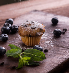 Blueberry and chocolate muffin on wooden background