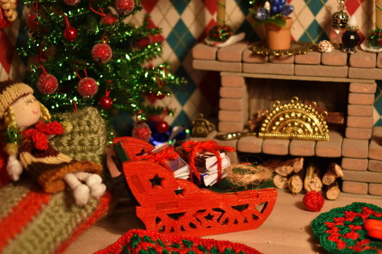 Christmas in dollhouse. Toy fireplace with decor. Handmade dollhouse for daughter.