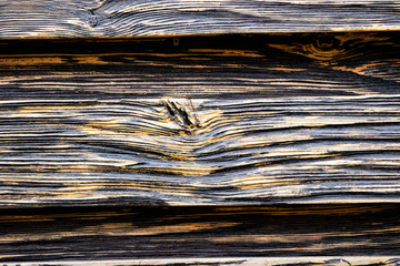 Fototapeta premium Aged wood texture. Boards are black and brown. Artificially aged wood. Deep texture. The concept of an old tree.