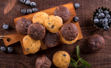 Blueberry and chocolate muffins on wooden background
