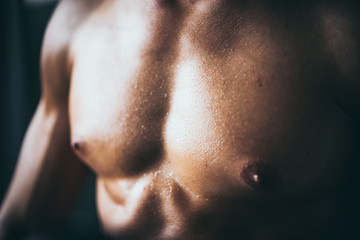 Fototapeta premium Muscular bodybuilder guy showing in gym