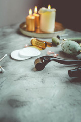 Dermaroller and serum next to an anti aging face cream Beauty industry Close-up Dermaroller for medical micro needling therapy Derma roller mesoroller for mesotherapy Copy space Selective focus