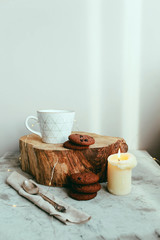 Cozy morning with cup of coffee with cream and autumn leaves Autumn and holiday concept. vintage clock on the background of leaves