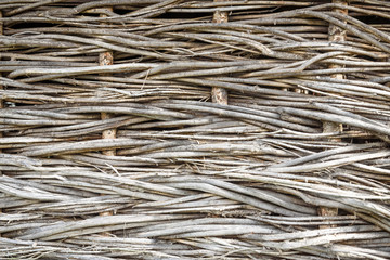 Texture background of the wall woven from dry branches