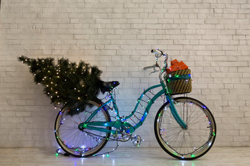 Fototapeta na wymiar Christmas greeting card with blue bicycle decorating by lights