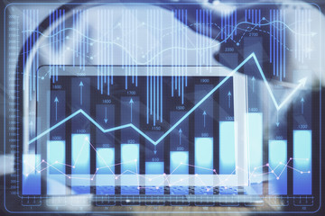 Financial graph colorful drawing and table with computer on background. Double exposure. Concept of international markets.