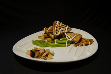 Delicious homemade waffles with kiwi and cream
