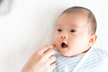 赤ちゃんの顔に触れる女性