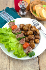 grilled potatoes and beef skewer on a plate