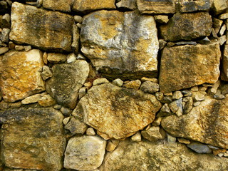 old stone wall of stones background