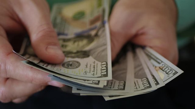 Man counting dollar bills. Business, banks. Buying and selling.
