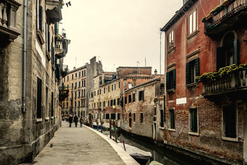 Fototapeta na wymiar Historic buildings by a narrow canal in Venice