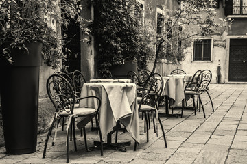 Tables and chairs in a small square in Venice