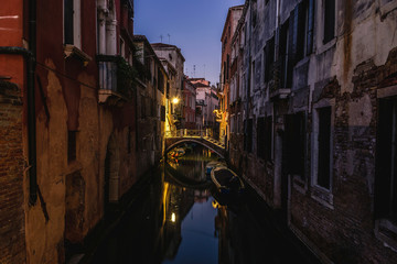 Narrow canal in Venice at night