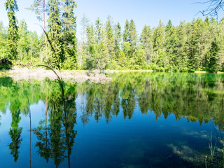Obraz premium landscape with bright green lake and colorful trees, beautiful summer day, wonderful reflections in the water