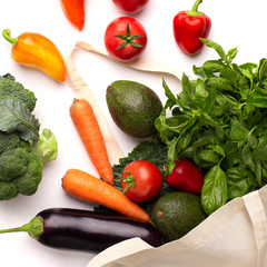 Fresh and colored vegetables in organic shopping bag