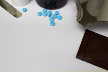 Medical background with blue tablets on drugstore table counter with copy space