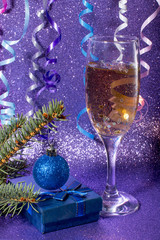 New year celebration in 2020. A glass of champagne on a blue background.