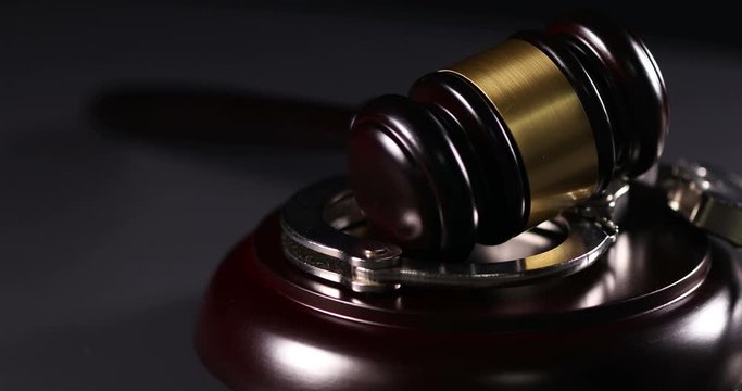 4k Handcuffs and Gavel Rotation Closeup On Dark Background.