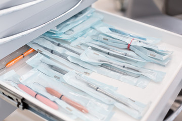Close up of dentist tools in open drawer
