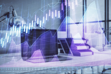 Forex graph hologram with desktop office computer background. Double exposure. Concept of financial...