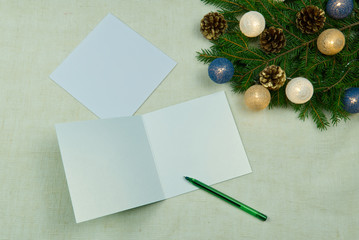 Christmas letter writing on a natural linen bedspread. Eco Christmas is always in fashion. Can be used as postcards, backgrounds, wallpapers, posters ... Christmas composition flat lay with Mockup.