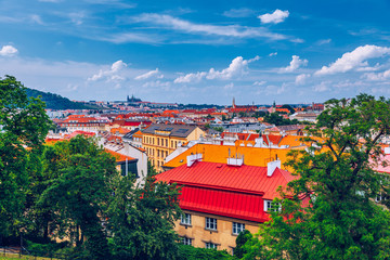 View of Prague Castle over red roof from Vysehrad area at sunset lights, Prague, Czech Republic. Scenic view of Prague city, Prague castle and Petrin tower from Vysehrad overlooking red roofs