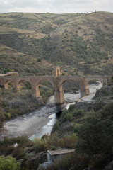 Fototapeta na wymiar Roman bridge of Alcantara in arch built between 103 and 104. It crosses the Tajo river.