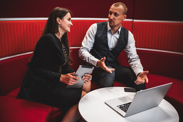 Business meeting of two colleagues with selective focus on a caucasian woman entrepreneur with a...