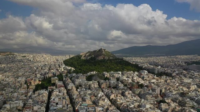 Aerial drone panoramic video of Lycabettus hill with beautiful sky and clouds, Athens historic centre, Attica, Greece