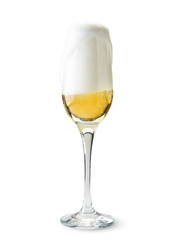 Full glass of champagne, foam pours over the top on a white background.