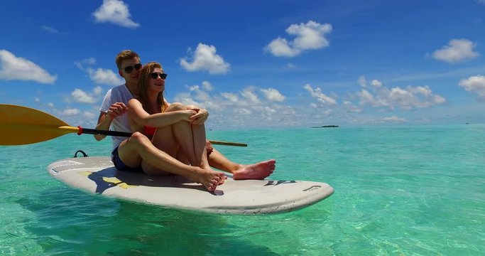 Couple Enjoying Their Time In The Philippines On A Paddleboard, honeymoon travel destination