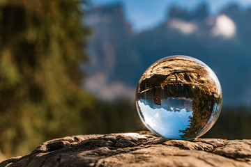 Crystal ball alpine landscape shot at the famous Karersee, South Tyrol, Italy