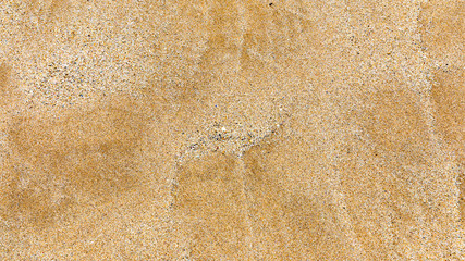 Sand surface and background. Sand Texture. Brown sand. Background from fine sand. Sand background. Closeup of sand pattern of a beach in the summer.