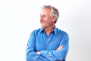 Studio Shot Of Mature Man Against White Background Laughing At Camera
