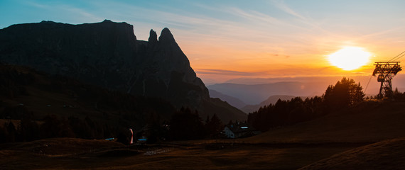 Beautiful alpine sunset view with the fantastic Schlern summit silhouette at the famous Seiser Alm, South Tyrol, Italy