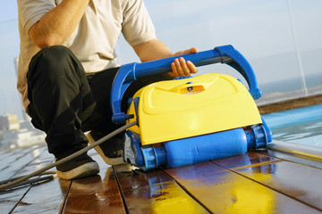 Pool cleaner during his work. Cleaning robot for cleaning the botton of swimming pools. Automatic pool cleaners. 