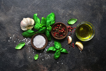Culinary background with traditional italian spices : basil, garlic, sea salt, pepper and olive...