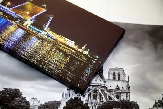 Photography canvas prints on white wooden background. Travel photos printed on glossy synthetic canvas