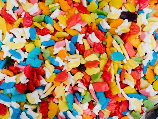 Fototapeta na wymiar Abstract background of mixed marmalade. A lot of multi-colored chewing sweets, top view
