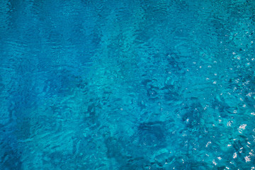 Blue ripped water in swimming pool. Surface of blue swimming pool, background of water in swimming pool. Water swimming pool texture and surface water on pool. Blue ripped water in swimming pool.