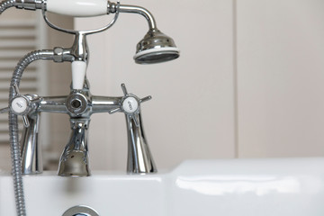 Luxury bathroom interior with classic rolltop bath tub and vintage tap