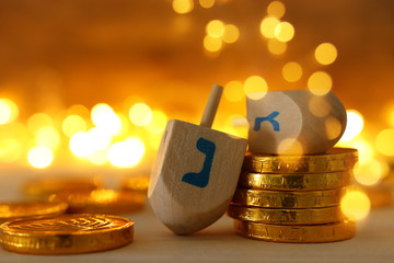 religion concept of of jewish holiday Hanukkah with wooden dreidels (spinning top) and chocolate...