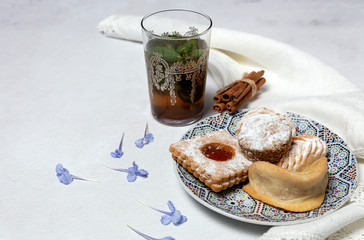 Traditional tea with mint and assorted Arab sweets