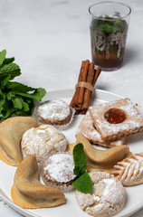 Traditional tea with mint and assorted Arab sweets