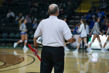 A line judge holds the ball and flag during timeout