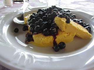 Italian molded zabaione ice cream or gelato called spumone with fresh bilberries or european blueberries