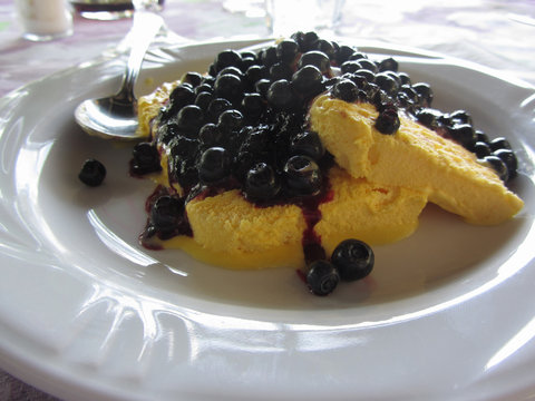 Italian molded zabaione ice cream or gelato called spumone with fresh bilberries or european blueberries