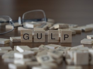 The concept of gulp represented by wooden letter tiles