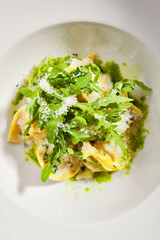 Tortellini with rabbit meat pesto sauce and arugula